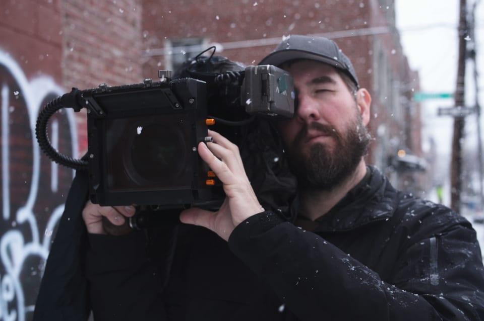 James Peterson operating a cinema camera in falling snow