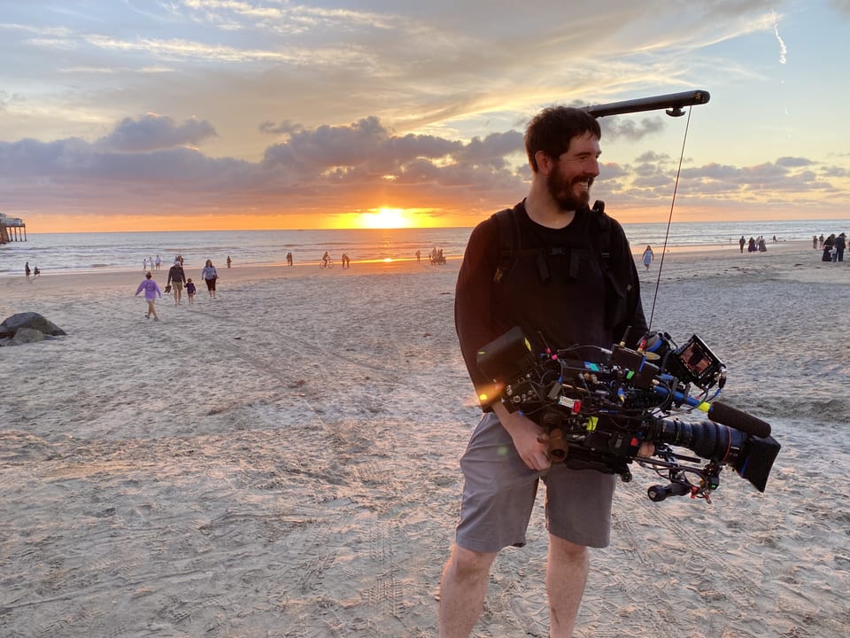 James Peterson with a camera rig at sunset on the beach